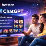 Illustration of a couple watching television at home as the Jio Hotstar app displays a ChatGPT-powered recommendation interface, showing personalized prompts like “What should I watch?” along with suggested movies and shows on screen
